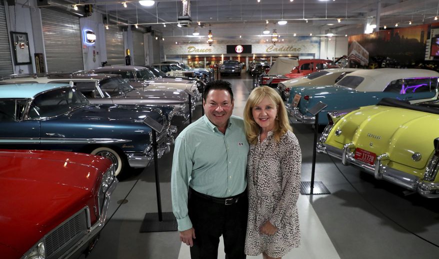 Joanne and Edward Dauer pose at the Dauer Museum of Classic Cars in Sunrise, Fla., on Wednesday, April 21, 2021. (Carline Jean/South Florida Sun-Sentinel via AP)