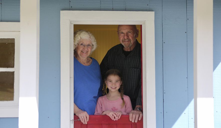 Mavis and Jim Meyer are pictured with their soon-to-be-adopted daughter Annabella at their Ferndale, Montana, home on April 2, 2021. (Mackenzie Reiss/Daily Inter Lake via AP)