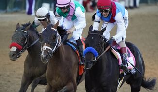 John Velazquez riding Medina Spirit leads Florent Geroux on Mandaloun and Flavien Prat riding Hot Rod Charlie to win the 147th running of the Kentucky Derby at Churchill Downs, Saturday, May 1, 2021, in Louisville, Ky. (AP Photo/Jeff Roberson)
