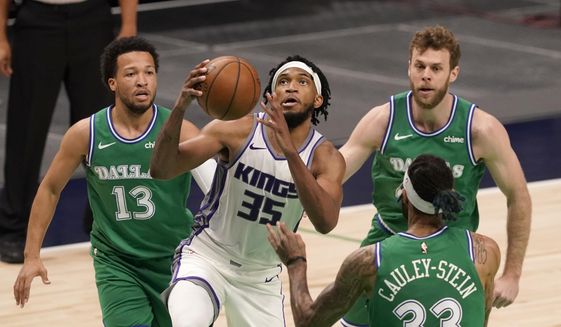 Sacramento Kings forward Marvin Bagley III (35) goes up for a shot between Dallas Mavericks&#39; Jalen Brunson (13), Willie Cauley-Stein (33) and Nicolo Melli, right rear, in the second half of an NBA basketball game in Dallas, Sunday, May 2, 2021. (AP Photo/Tony Gutierrez)
