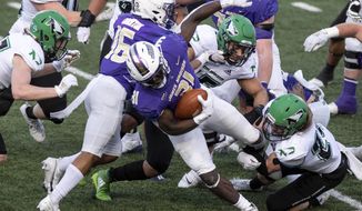 James Madison running back Percy Agyei-Obese (31) bursts out of traffic during the first half of a quarterfinal game against North Dakota in the NCAA FCS football playoffs in Harrisonburg, Va., Sunday, May 2, 2021. (Daniel Lin/Daily News-Record via AP)