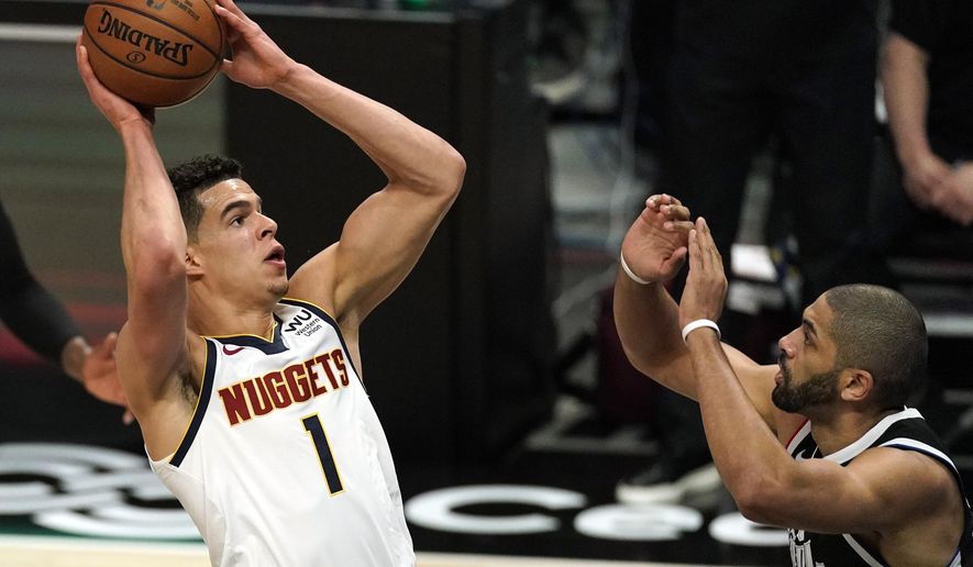 Denver Nuggets forward Michael Porter Jr., left, shoots as Los Angeles Clippers forward Nicolas Batum defends during the first half of an NBA basketball game Saturday, May 1, 2021, in Los Angeles. (AP Photo/Mark J. Terrill)