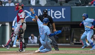 Texas Rangers&#39; Isiah Kiner-Falefa (9) scores on a go-ahead RBI single by Brock Holt as home plate umpire Brian O&#39;Nora and Boston Red Sox catcher Kevin Plawecki look on while Texas Rangers&#39; Willie Calhoun celebrates in the background during the eighth inning of a baseball game Sunday, May 2, 2021, in Arlington, Texas. (AP Photo/Jeffrey McWhorter)