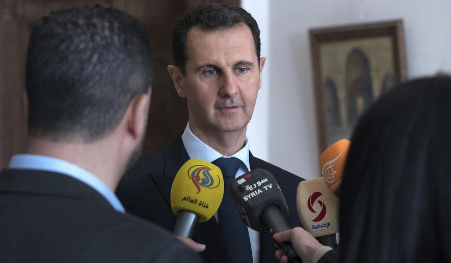 FILE - In this March 4, 2018 file photo, provided by the official Facebook page of the Syrian Presidency, Syrian President Bashar Assad speaks with reporters in Damascus, Syria. Assad issued a decree Sunday, May 2, 2021, granting amnesty and reducing sentences for several categories of crime committed before May 2, state news agency SANA said. The amnesty came days before Muslims celebrate Eid el-Fitr, the feast that marks the end of the Muslim holy month of Ramadan and ahead of the May 26 presidential elections. (Syrian Presidency Facebook Page via AP, File)