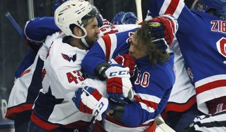 Washington Capitals&#39; Tom Wilson (43) takes a roughing penalty during the second period against New York Rangers&#39; Artemi Panarin (10) in an NHL hockey game Monday, May 3, 2021, in New York. (Bruce Bennett/Pool Photo via AP)
