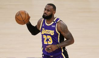 Los Angeles Lakers forward LeBron James dribbles during the first half of an NBA basketball game against the Sacramento Kings Friday, April 30, 2021, in Los Angeles. (AP Photo/Marcio Jose Sanchez)