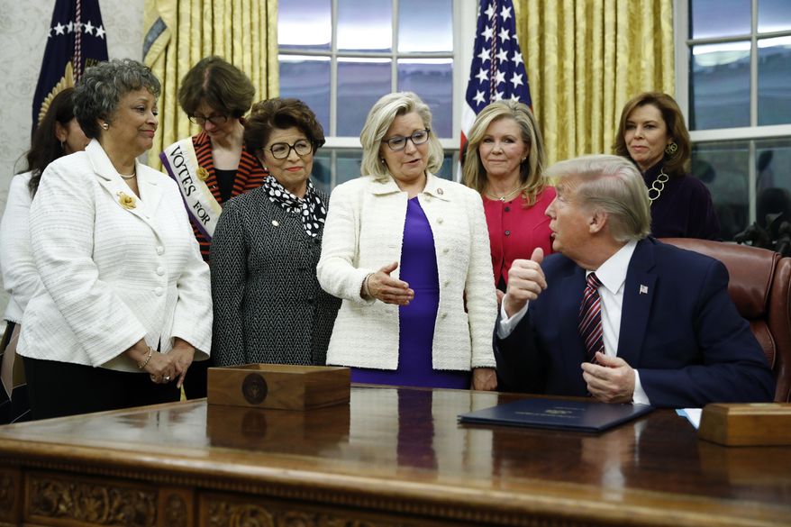 In this Nov. 25, 2019, file photo, Rep. Liz Cheney, R-Wyo., center, speaks with President Donald Trump during a bill signing ceremony for the Women&#39;s Suffrage Centennial Commemorative Coin Act in the Oval Office of the White House in Washington. (AP Photo/Patrick Semansky, File)