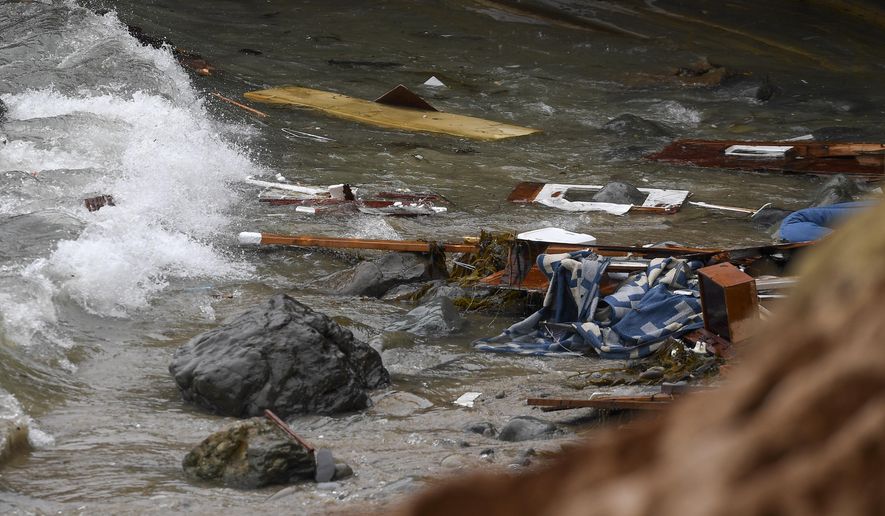 Wreckage and debris from a capsized boat washes ashore at Cabrillo National Monument near where a boat capsized just off the San Diego coast Sunday, May 2, 2021, in San Diego. (AP Photo/Denis Poroy)