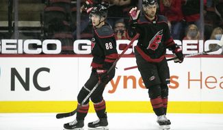 Carolina Hurricanes&#39; Martin Necas (88) celebrates his goal with teammate Nino Niederreiter (21) during the first period of an NHL hockey game against the Chicago Blackhawks in Raleigh, N.C., Monday, May 3, 2021. (AP Photo/Karl B DeBlaker)