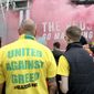 A fan wears a shirt with a &amp;quot;United Against Greed&amp;quot; message, as fans gather to protest against the Glazer family, the owners of Manchester United, outside Old Trafford stadium, in Manchester, England, before their English Premier League match against Liverpool, Sunday, May 2, 2021. Manchester United supporters have stormed into the stadium and onto the pitch ahead of Sunday&#39;s game against Liverpool as fans gathered outside Old Trafford to protest against the Glazer ownership. (Barrington Coombs/PA via AP) **FILE**