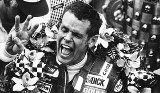 FILE - In this May 24, 1981, file photo, Bobby Unser holds three fingers aloft after winning his third Indianapolis 500 auto race ,in Indianapolis, Ind. Three-time Indianapolis 500 winner Bobby Unser has died. He died of natural causes at his home in Albuquerque, New Mexico, on Sunday, May 2, 2021. He was 87. (AP Photo/File)