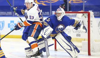 Buffalo Sabres goalie Michael Houser (32) is bumped into by New York Islanders forward Casey Cizikas (53) during the second period of an NHL hockey game, Monday, May 3, 2021, in Buffalo, N.Y. (AP Photo/Jeffrey T. Barnes)