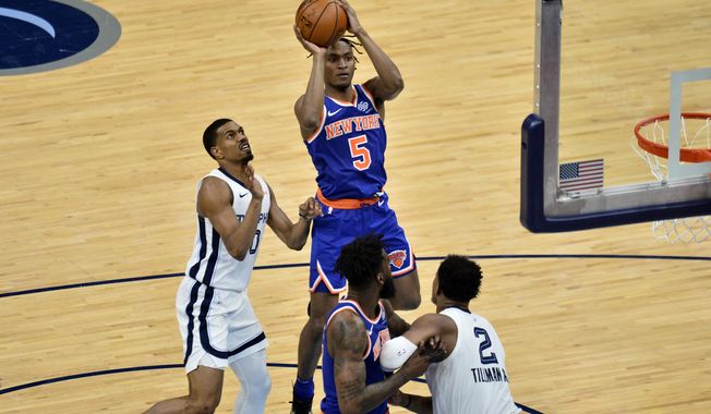 New York Knicks guard Immanuel Quickley (5) shoots ahead of Memphis Grizzlies guard De&#x27;Anthony Melton (0) in the second half of an NBA basketball game Monday, May 3, 2021, in Memphis, Tenn. (AP Photo/Brandon Dill)