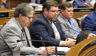 Reps. Bill Wheat, R-Ponchatoula, from left, Chris Turner, R-Ruston; and Troy Romero, R-Jennings, look through budget documents during a meeting of the House Appropriations Committee on Monday, May 3, 2021, in Baton Rouge, La. (AP Photo/Melinda Deslatte)