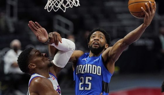 Orlando Magic guard Chasson Randle (25) makes a layup as Detroit Pistons forward Tyler Cook defends during the second half of an NBA basketball game, Monday, May 3, 2021, in Detroit. (AP Photo/Carlos Osorio)