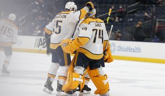 Nashville Predators&#39; Brad Richardson, left, congratulates Juuse Saros after their win over the Columbus Blue Jackets&#39; in an NHL hockey game Monday, May 3, 2021, in Columbus, Ohio. (AP Photo/Jay LaPrete)