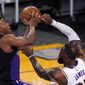 Toronto Raptors guard Kyle Lowry, left, shoots as Los Angeles Lakers forward LeBron James defends during the first half of an NBA basketball game Sunday, May 2, 2021, in Los Angeles. (AP Photo/Mark J. Terrill)
