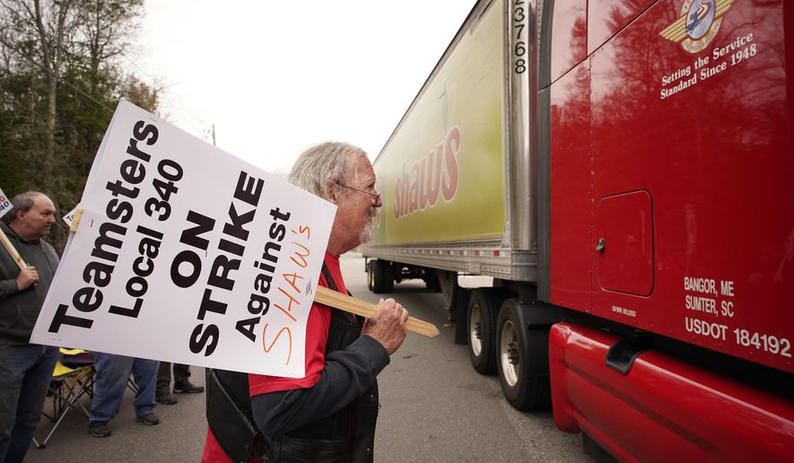 Jim Kelly, a truck driver with Shaw&#39;s supermarkets, looks at the driver of a truck leaving a Shaw&#39;s distribution facility while walking a picket line on strike, Monday, May 3, 2021, in Wells, Maine. Truck drivers for Shaw&#39;s supermarkets represented by the Teamsters went on strike Monday, May 3, stopping shipments to Shaw&#39;s and Star Market grocery stores in New England. (Gregory Rec/Portland Press Herald via AP)