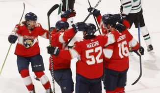 Teammates celebrate the game-winning goal by Florida Panthers center Aleksander Barkov (16) during the overtime period of an NHL hockey game, Monday, May 3, 2021, in Sunrise, Fla. (AP Photo/Joel Auerbach)