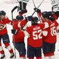 Teammates celebrate the game-winning goal by Florida Panthers center Aleksander Barkov (16) during the overtime period of an NHL hockey game, Monday, May 3, 2021, in Sunrise, Fla. (AP Photo/Joel Auerbach)