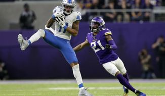 File-This Dec. 8, 2019, file photo shows Detroit Lions wide receiver Marvin Jones catching a pass ahead of Minnesota Vikings cornerback Mike Hughes, right, during the first half of an NFL football game, in Minneapolis. The Vikings have declined the fifth-year contract option for Hughes. The 2018 first-round pick has missed more than half of the games to injuries since he was drafted. Neck trouble that first occurred in 2019 continued last season and limited him to four games.  (AP Photo/Andy Clayton-King, File)