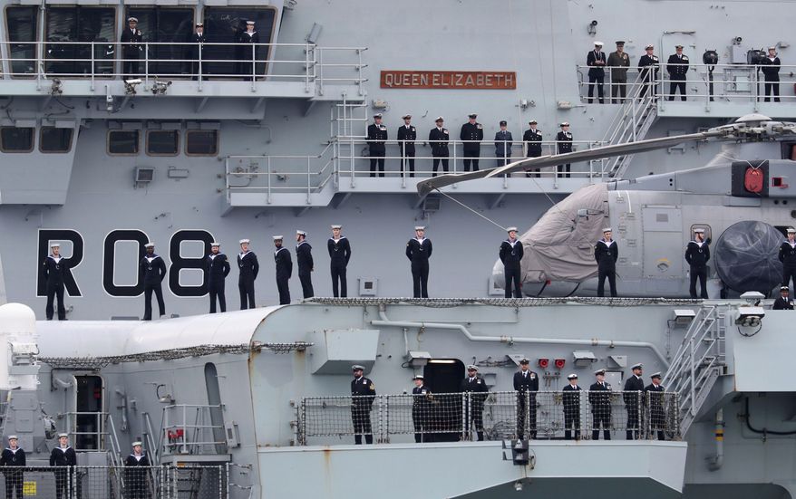 The HMS Queen Elizabeth left Portsmouth Naval Base on Saturday for exercises off Scotland before a 28-week trip through the Pacific that will take the Royal Navy to more than 40 countries. (Associated Press)