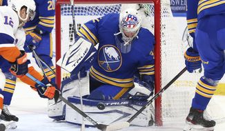 Buffalo Sabres goalie Michael Houser (32) makes a save in traffic during the second period of an NHL hockey game against the New York Islanders, Tuesday, May 4, 2021, in Buffalo, N.Y. (AP Photo/Jeffrey T. Barnes)