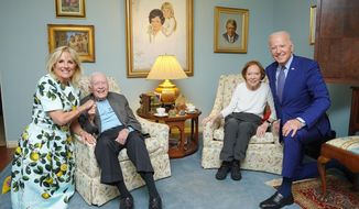 In this April 30, 2021, photo released by The White House, former President Jimmy Carter and former first lady Rosalynn Carter pose for a photo with President Joe Biden and first lady Jill Biden at the home of the Carter&#39;s in Plains Ga. (Adam Schultz, The White House via AP)