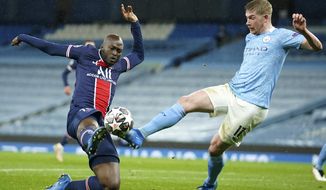 PSG&#39;s Danilo Pereira, left, challenges Manchester City&#39;s Kevin De Bruyne during the Champions League semifinal second leg soccer match between Manchester City and Paris Saint Germain at the Etihad stadium, in Manchester, Tuesday, May 4, 2021. (AP Photo/Dave Thompson)