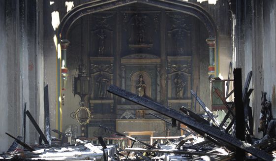 In this Saturday, July 11, 2020, file photo, the interior of the San Gabriel Mission is seen in the aftermath of an early morning fire in San Gabriel, Calif.  A fire that gutted much of the historic Catholic church in Southern California last year was intentionally set by a 57-year-old man, prosecutors said Tuesday, May 4, 2021. John David Corey faces multiple felony counts including arson of an inhabited structure, the Los Angeles County District Attorney&#39;s Office said in a statement  (AP Photo/Marcio Jose Sanchez, File)