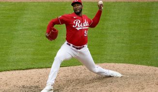 Cincinnati Reds relief pitcher Amir Garrett throws in the 10th inning during a baseball game against the Chicago Cubs in Cincinnati on Sunday, May 2, 2021. (AP Photo/Jeff Dean)