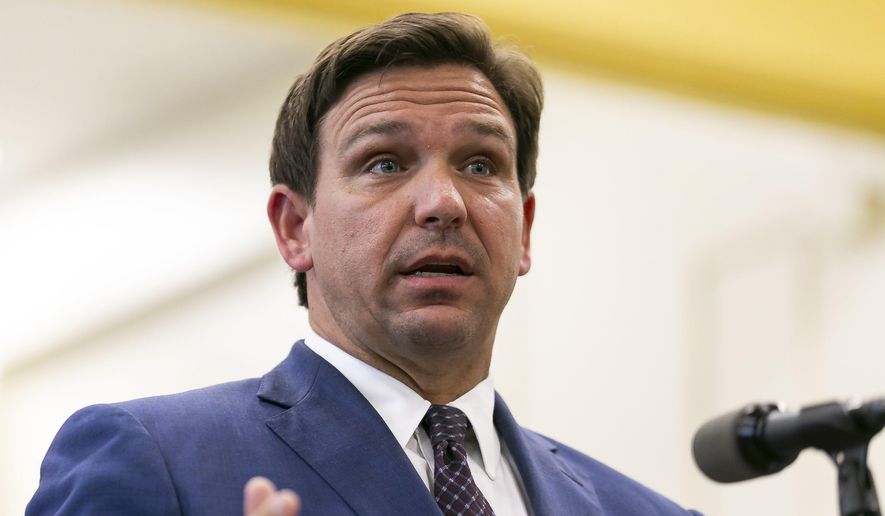 Florida Gov. Ron DeSantis, center, speaks during a news conference at West Miami Middle School in Miami on Tuesday, May 4, 2021. (Matias J. Ocner/Miami Herald via AP) ** FILE **
