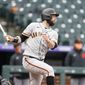 San Francisco Giants&#39; Brandon Belt follows the flight of his single off Colorado Rockies relief pitcher Jhoulys Chacin in the fourth inning of game one of a baseball doubleheader Tuesday, May 4, 2021, in Denver. (AP Photo/David Zalubowski)