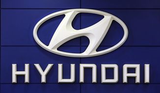 FILE - This July 26 2018 file photo shows the logo of Hyundai Motor Co. in Seoul, South Korea. Hyundai is recalling over 390,000 vehicles in the U.S. and Canada, Tuesday, May 4, 2021,  for problems that can cause engine fires. In one recall, owners are being told to park outdoors until repairs are made. That recall covers more than 203,000 Santa Fe Sport SUVs from 2013 through 2015.  (AP Photo/Ahn Young-joon, File)