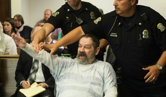 FILE - In this Nov. 10, 2015, file photo, Frazier Glenn Miller Jr., convicted of capital murder, attempted murder and other charges, gestures as Johnson County deputies remove Miller from the courtroom during the sentencing phase of his trial at the Johnson County District Court in Olathe, Kan. Miller, an avowed anti-Semite who fatally shot three people at Jewish sites in Kansas has died in prison, Monday, May 3, 2021, at the El Dorado Correctional Facility. (Joe Ledford/The Kansas City Star via AP, Pool, File)