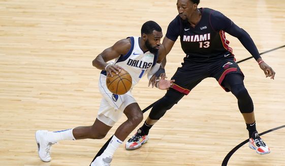 Dallas Mavericks forward Tim Hardaway Jr. (11) drives up against Miami Heat center Bam Adebayo (13) during the first half of an NBA basketball game, Tuesday, May 4, 2021, in Miami. (AP Photo/Wilfredo Lee)