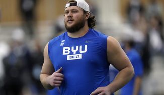 FILE - BYU offensive lineman Brady Christensen runs down field during the school&#39;s Pro Day football workout for NFL scouts in Provo, Utah, in this Friday, March 26, 2021, file photo. The Panthers are hoping 24-year Brady Christensen came help solidify the left tackle position that has been a revolving door ever since Jordan Gross retired nearly a decade ago. The third-round pick from BYU is looking to do the same. (AP Photo/Rick Bowmer, File)