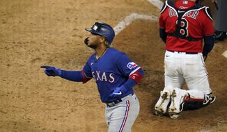 Texas Rangers&#39; Willie Calhoun scores on a solo home run in the ninth inning of a baseball game, Tuesday, May 4, 2021, in Minneapolis. (AP Photo/Jim Mone)