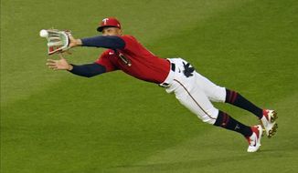 Minnesota Twins center fielder Byron Buxton makes a diving catch of a fly ball off the bat of Texas Rangers&#39; David Dahl in the seventh inning of a baseball game, Tuesday, May 4, 2021, in Minneapolis. (AP Photo/Jim Mone)