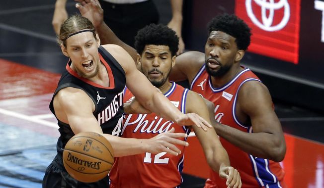 Houston Rockets forward Kelly Olynyk, left, loses the ball in front of Philadelphia 76ers forward Tobias Harris (12) and center Joel Embiid, right, during the first half of an NBA basketball game Wednesday, May 5, 2021, in Houston. (AP Photo/Michael Wyke, Pool)
