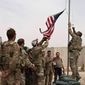 A U.S. flag is lowered as American and Afghan soldiers attend a handover ceremony from the U.S. Army to the Afghan National Army, at Camp Anthonic, in Helmand province, southern Afghanistan, Sunday, May 2, 2021. (Afghan Ministry of Defense Press Office via AP)
