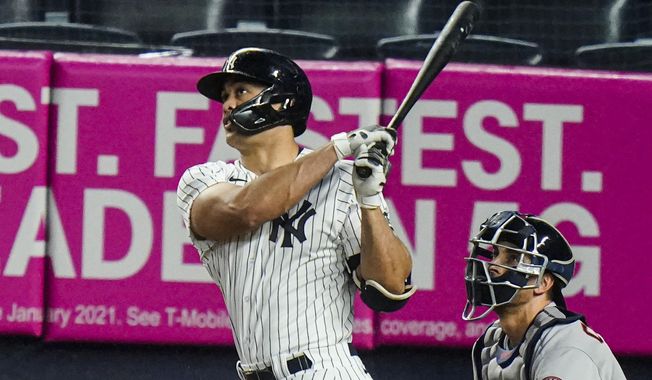New York Yankees&#x27; Giancarlo Stanton follows through on a two-run home run during the third inning of a baseball game against the Houston Astros Wednesday, May 5, 2021, in New York. (AP Photo/Frank Franklin II)