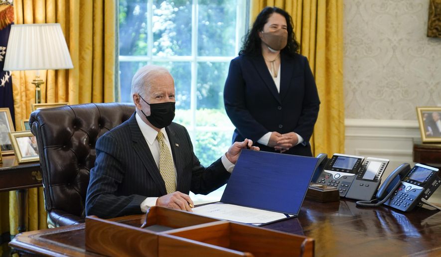 In this March 30, 2021 photo, President Joe Biden signs the PPP Extension Act of 2021, in the Oval Office of the White House in Washington. Small Business Administration administrator Isabel Guzman is at right. Biden is promoting his $28.6 billion program to help the restaurants, bars and food trucks hurt by the coronavirus pandemic. Biden plans to highlight the initiative in a Wednesday afternoon speech.(AP Photo/Evan Vucci)