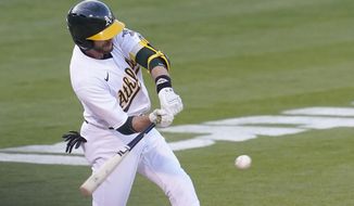 Oakland Athletics&#39; Jed Lowrie hits a two-run double against the Toronto Blue Jays during the second inning of a baseball game in Oakland, Calif., Tuesday, May 4, 2021. (AP Photo/Jeff Chiu)