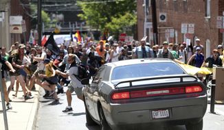 In this Aug. 12, 2017, file photo, a vehicle drives into a group of protesters demonstrating against a White nationalist rally in Charlottesville, Va. Bill Burke says he was struck by a car driven by James Alex Fields Jr., in a crash that killed counterprotester Heather Heyer, during the August 2017 rally in Charlottesville. (Ryan M. Kelly/The Daily Progress via AP) ** FILE **