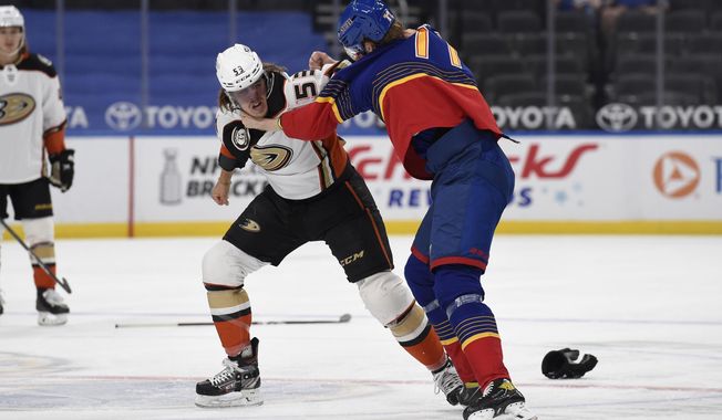 Anaheim Ducks&#x27; Max Comtois (53) gets physical with St. Louis Blues&#x27; Niko Mikkola (77) during the first period of an NHL hockey game on Wednesday, May 5, 2021, in St. Louis. (AP Photo/Joe Puetz)