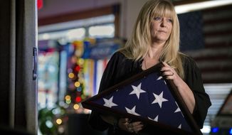 Kathy Davis pauses while thinking of her late son Cpl. Kindall Johnson, on April 9, 2021, in Springfield, Mo. Everyday Davis still mourns the loss of her son, a veteran of the U.S. Marine Corps who took his own life outside a police station in 2015 in Springfield. He was laid to rest with full military honors. (Tammy Ljungblad/The Kansas City Star via AP)