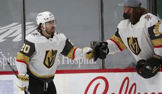Vegas Golden Knights center Chandler Stephenson (20) is congratulated by goaltender Robin Lehner after scoring against the Minnesota Wild during the second period during an NHL hockey game, Wednesday, May 5, 2021, in St. Paul, Minn. (AP Photo/Andy Clayton-King)