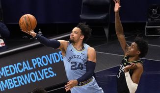 Memphis Grizzlies&#39; Dillon Brooks (24) shoots past Minnesota Timberwolves&#39; Jaden McDaniels (3) during the first half of an NBA basketball game Wednesday, May 5, 2021, in Minneapolis. (AP Photo/Jim Mone)