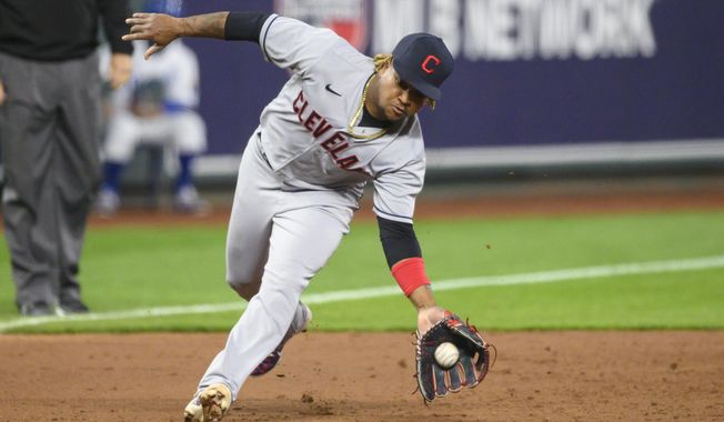 Cleveland Indians third baseman Jose Ramirez scoops up this grounder to throw out Kansas City Royals&#x27; Whit Merrifield for the third out in the sixth inning of a baseball game Tuesday, May 4, 2021, in Kansas City, Mo. (AP Photo/Reed Hoffmann)